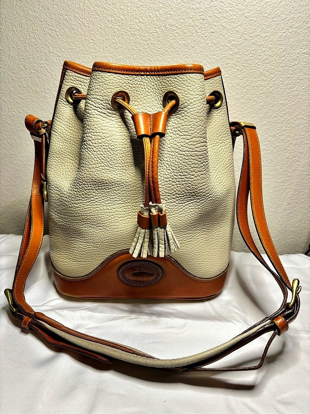 vintage Dooney & Bourke All Weather Leather Bucket Bag in Cream & Brown